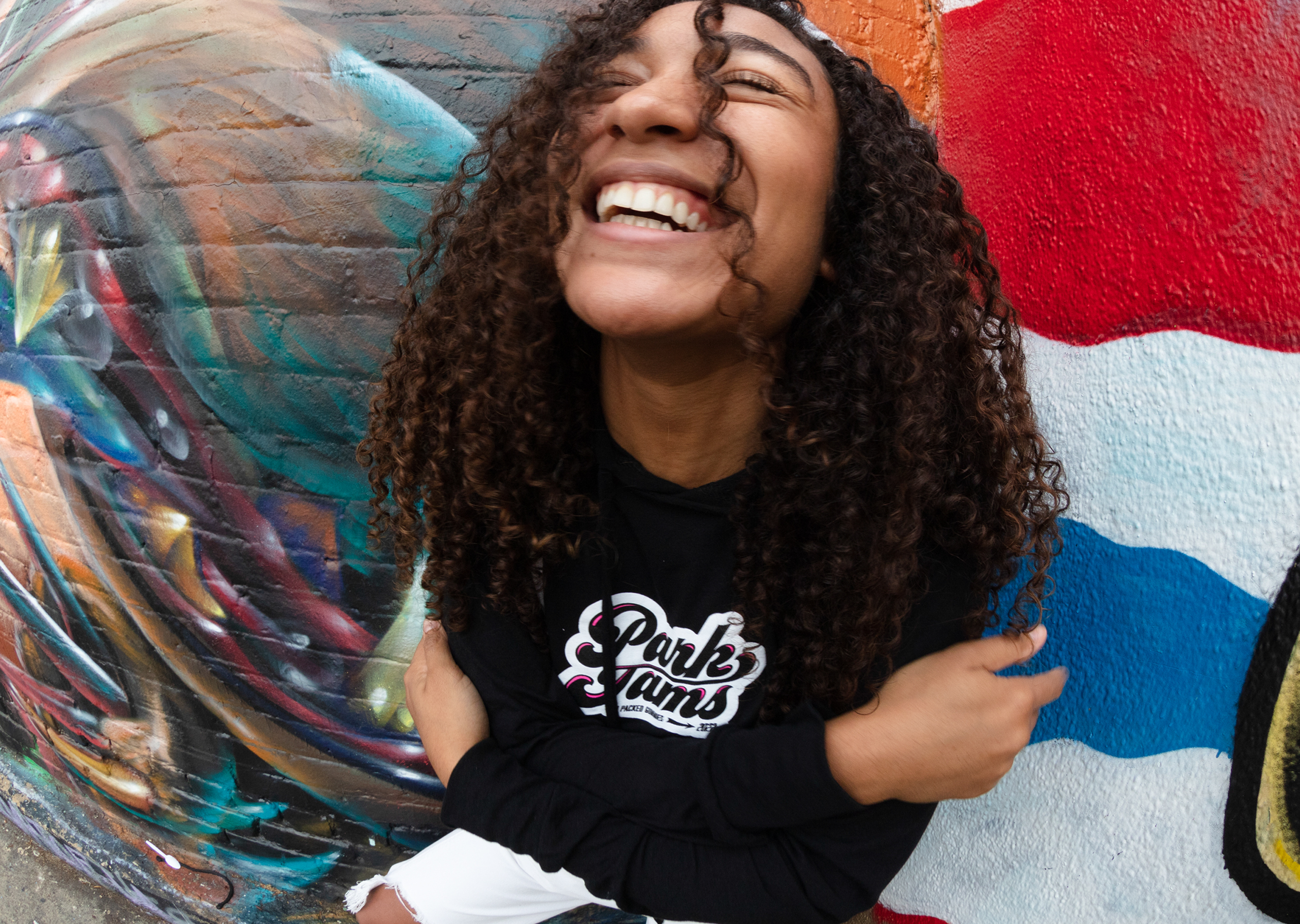 Woman in Park Jams hoodie smiling at the camera